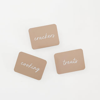 Three brown labels with white text on a white background